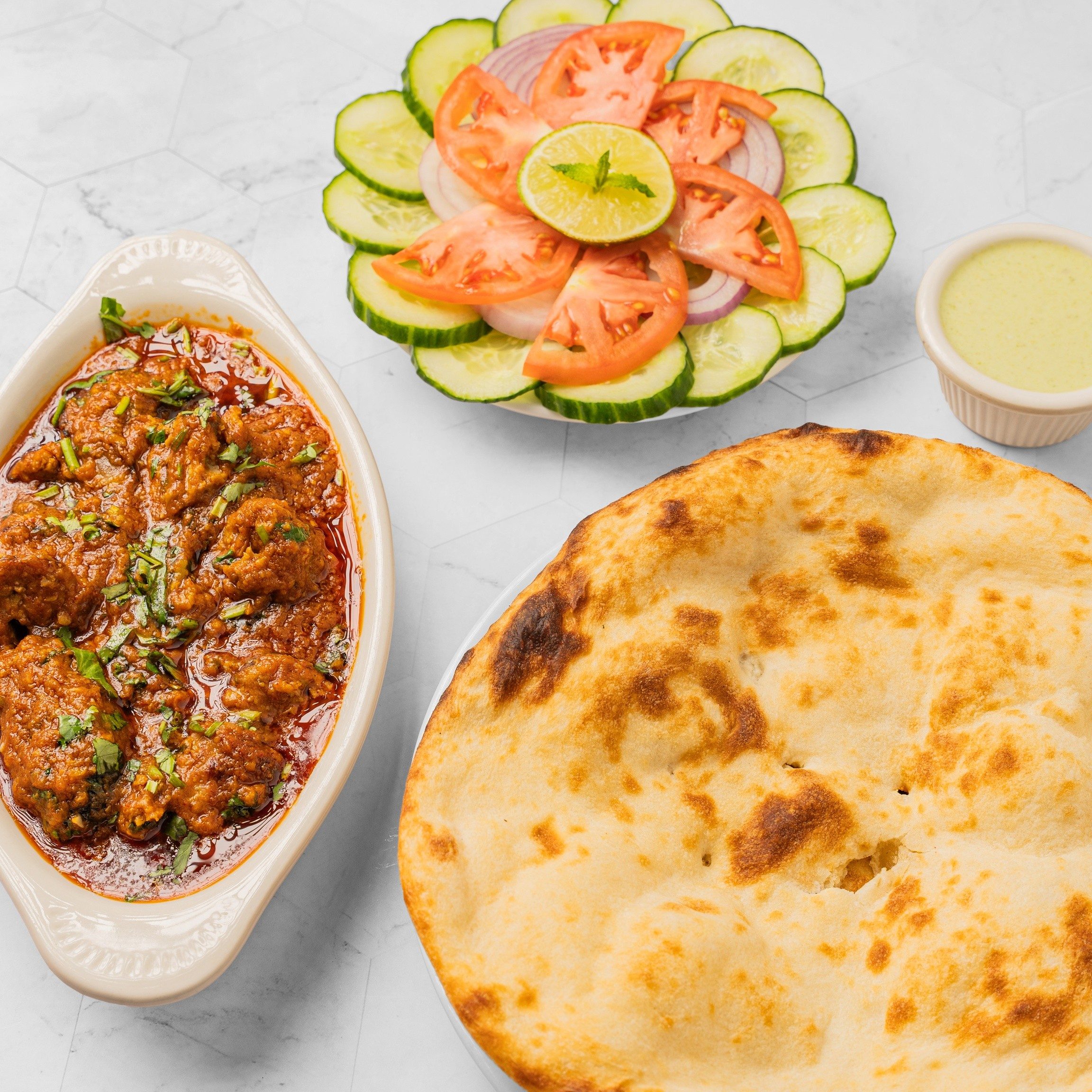 Goat Kadai (Half Pound) +2 Plain Naan + Can of Soda +Salad +Green Sauce.