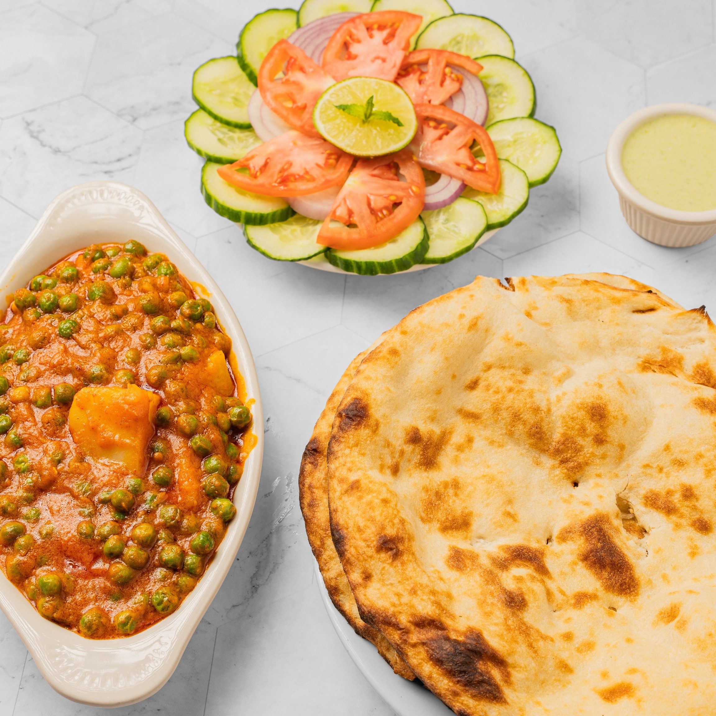 Any one vegetable dish in our menu +2 Plane Naan + Can of Soda +Salad +Green Sauce.